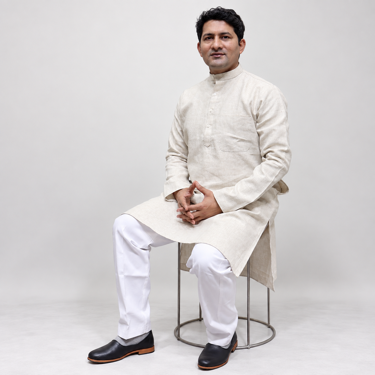 Cream Linen men’s kurta styled in traditional wear