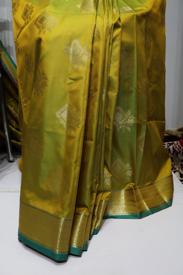 Olive Green Silk Saree with Gold Zari Motifs, Teal Border & Rich Traditional Pallu