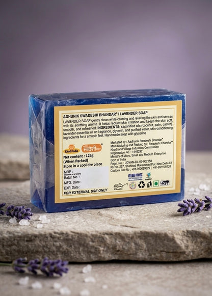 Lavender soap bar with packaging label on a stone surface