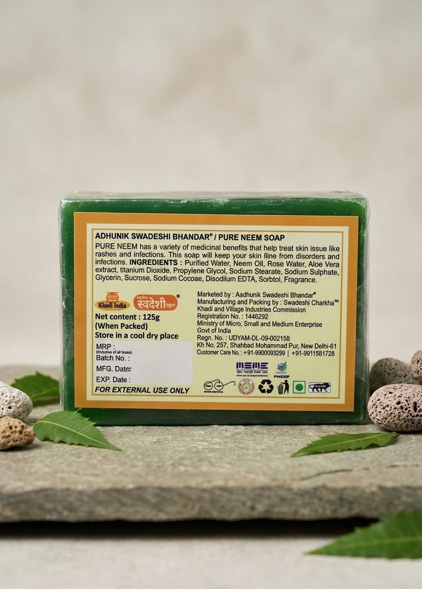 Pure Neem Soap packaging with text on a stone surface with leaves