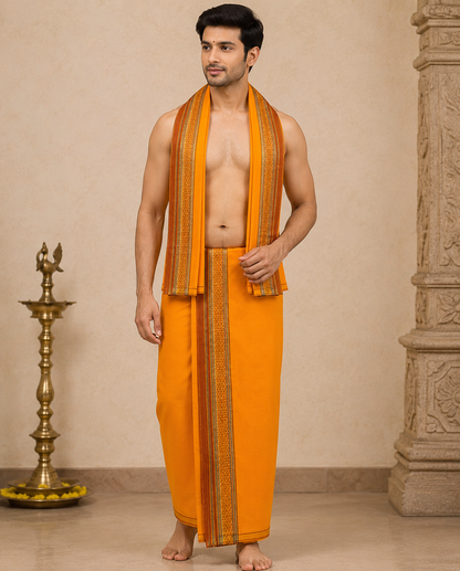 Man wearing orange cotton dhoti set with angavastram traditional South Indian style