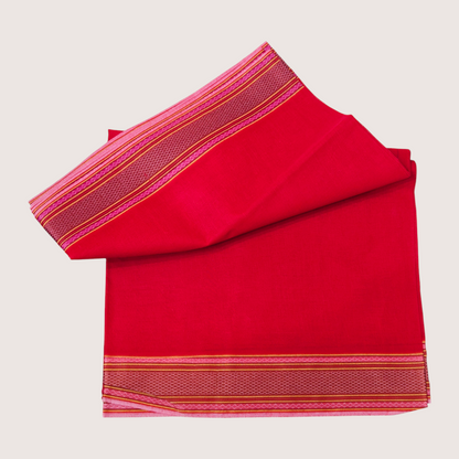 Folded red khadi cotton dhoti with orange woven border