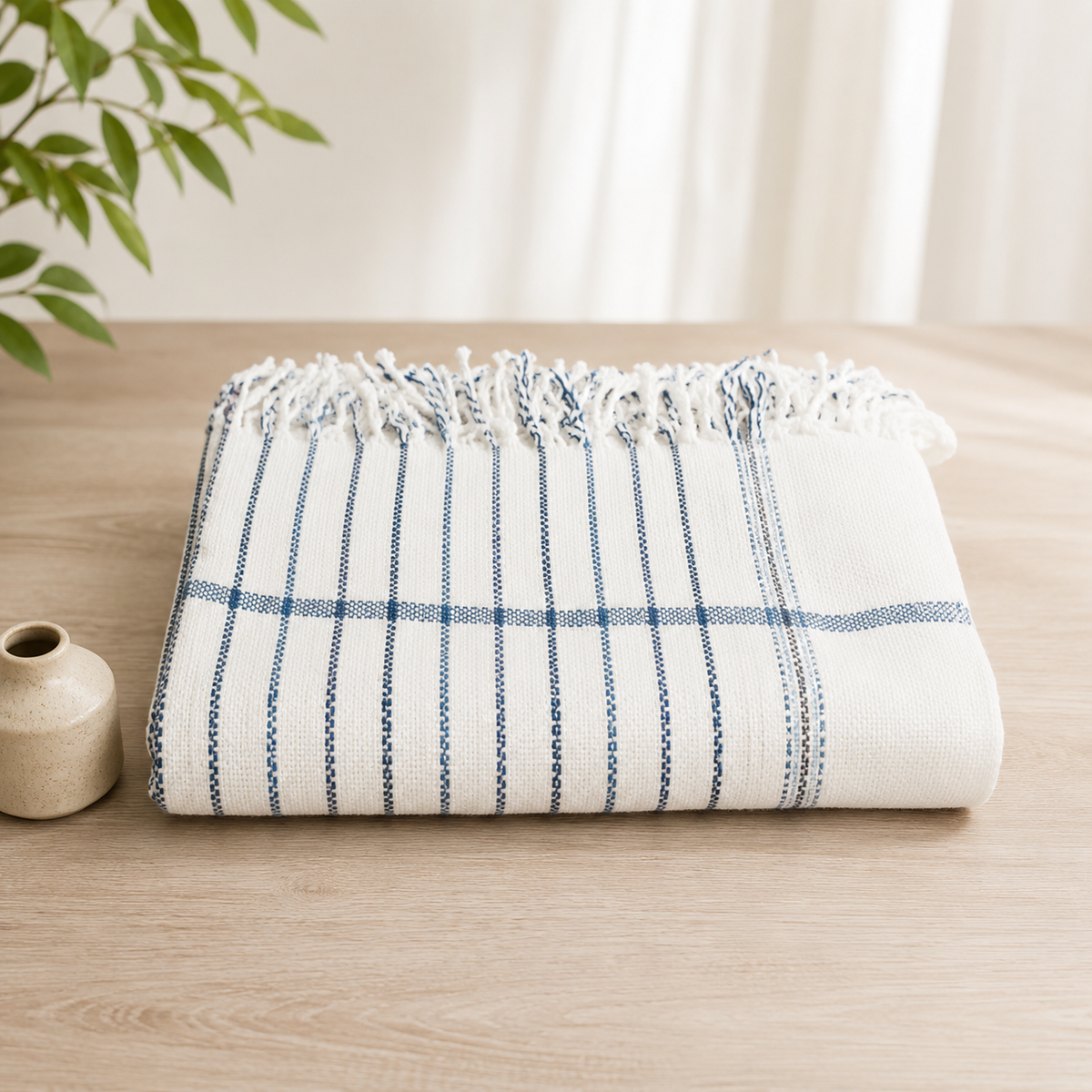White striped khadi cotton khesh with blue accents on wooden background