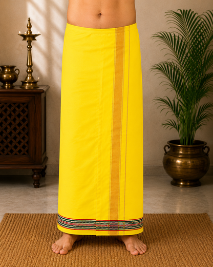 Model wearing premium yellow khadi cotton dhoti with multi-color striped border